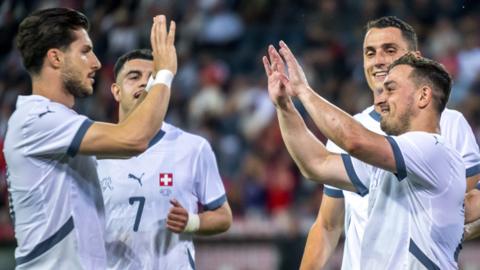 Switzerland celebrate scoring against Estonia