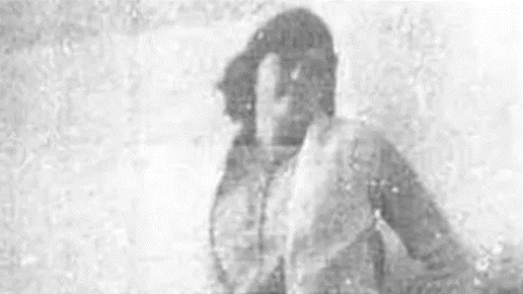 A black and white pixelated picture of a young woman with short dark hair. Only her outline can be made out. 