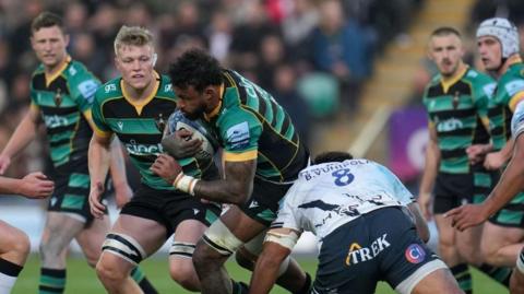 Courtney Lawes runs into a tackle with the ball