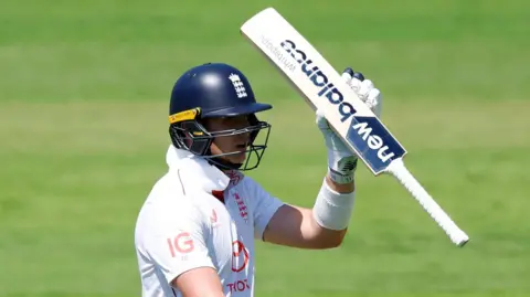 England batter Jamie Smith raises his bat after reaching fifty