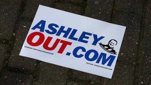 A poster saying AshleyOut.Com