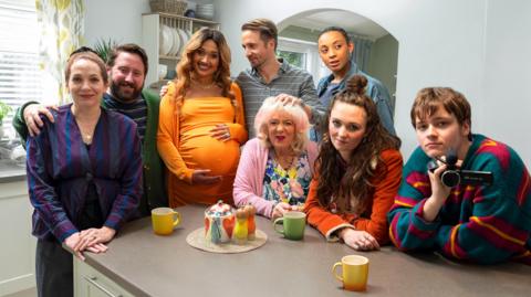 The Jessop family posing for a picture sat around a kitchen table