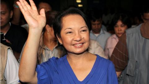 Gloria Macapagal Arroyo waves to supporters after winning a congressional seat on 12 May 2010, as she was leaving the post of president.