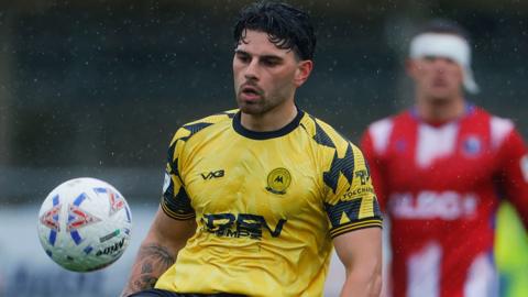 Callum Dolan juggles the ball on his right knee in a match for Torquay United