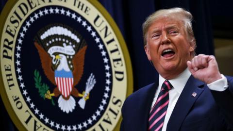 President Donald Trump pumps his fist after speaking at a White House Mental Health Summit at the White House on December 19, 2019