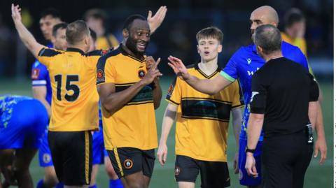 Rushall Olympic captain Nathan Cameron pleads with referee Steven Copeland over Luke Benbow's red card