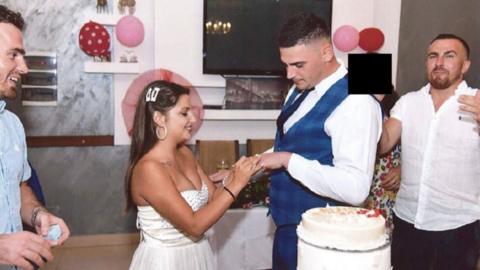 Couple getting married. There is a face of someone cut out.