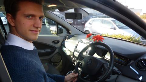 Matthew Thomason with his electric car