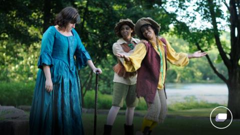 A photograph of Much Ado About Nothing play. From left, Jessica Feldman, Jada Harris, and Maya Spragley, in yellow. Shakespeare in the Park at Gring's Mill amphitheatre.