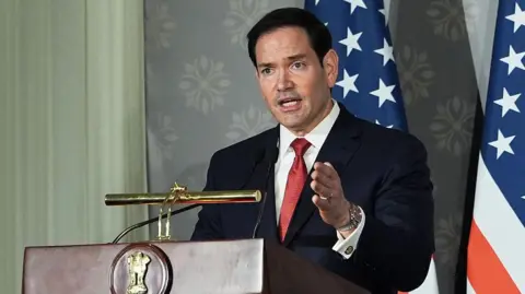 Marco Rubio stood behind a podium and microphone.
