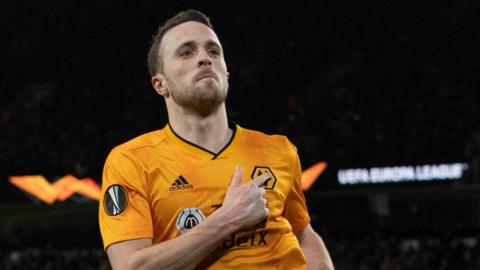Diogo Jota touches the Wolves badge in celebration 