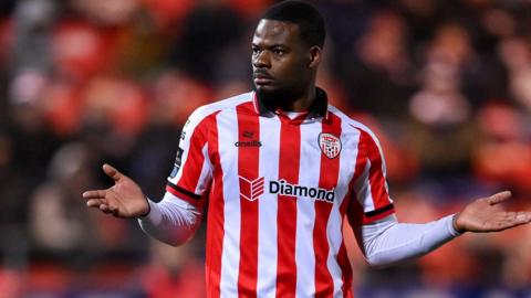 Dipo Akinyemi in action for Derry City in their red and white striped home shirt