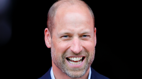 Prince William has a beard and smiles widely