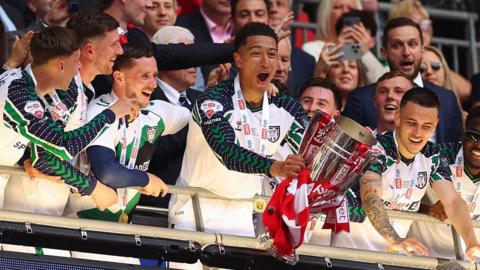 Sunderland lifting the EFL Championship trophy after 2025 play-off final. 