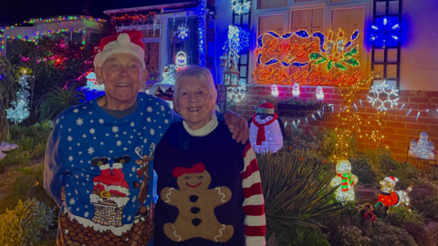Bill and Barbara Wright in front of their house