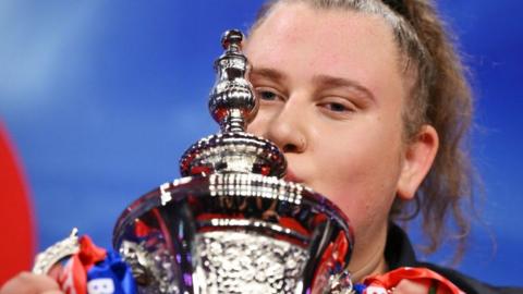 Beau Greaves with the Women's World Matchplay trophy in 2024