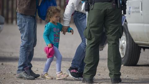 A migrant girl is detained after crossing illegally into the US in New Mexico in June 2019