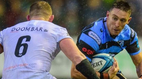 Cardiff's Josh Adams (R) takes on Jac Morgan of Ospreys