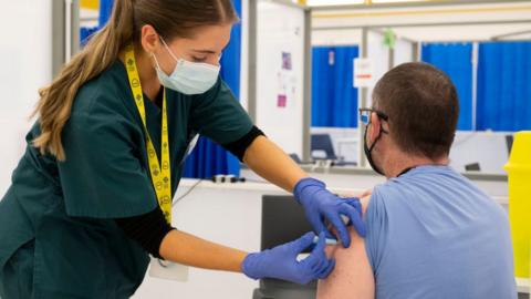 Booster vaccine being given