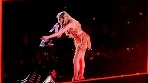 Taylor Swift yells to a security guard while performing