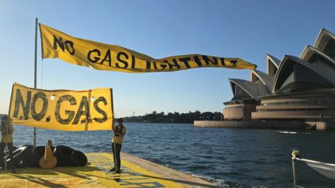 Climate activists protesting on a barge in Sydney Harbour against gas expansion plans