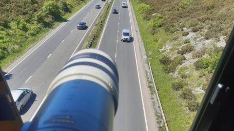 A speed camera on a bridge