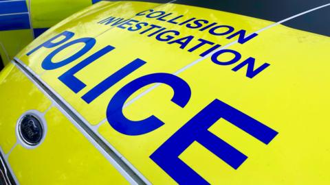 Close up photo of the front bonnet of a Police car which says 'collision investigation police' on it 