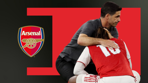 Mikel Arteta crouching down consoling Eberechi Eze, in front of a red and black background and the Arsenal club badge 