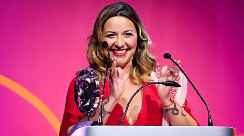 Charlotte Church, wearing a red dress, at the 2025 BAFTA Cymru Awards, held at the ICCW in Newport on Sunday 5 October.