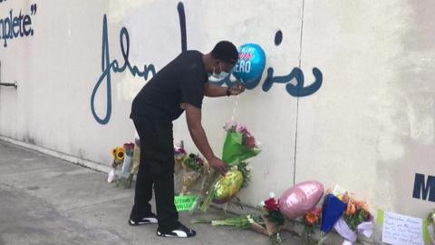 A man laying flowers