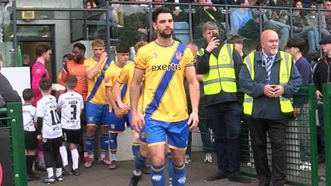 Basingstoke FC players walk out on to the pitch at the start of a game