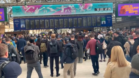 Dozens of commuters wait in the concourse at Glasgow Central