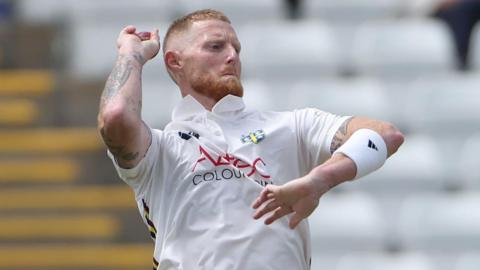 Ben Stokes in a white Durham shirt bowling