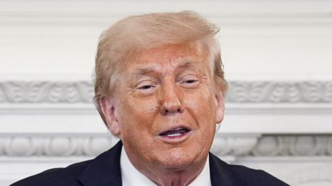 Donald Trump is smiling.