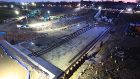 A night-time picture of major engineering works under the M27 motorway.