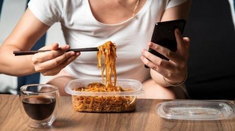A woman eating noodles