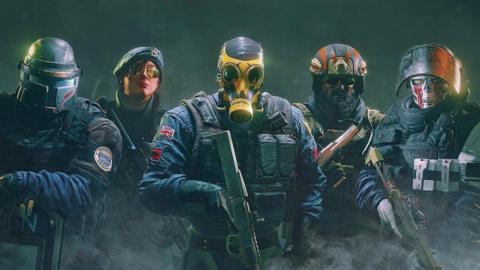 A promotional picture for Rainbow Six Siege featuring 5 soldiers looking into the camera from different militaries. The UK one is front and centre wearing a yellow gas mask and carrying a shotgun. 