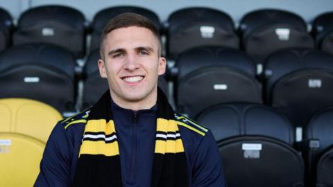 Owen Dodgson poses in the stands at Burton after singing from Burnley on loan