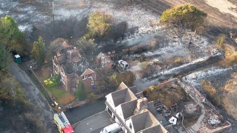 An aerial view shows burnt houses after fires in the West Midlands.