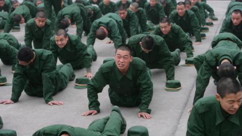 New recruits do pushups at a training base in Chongqing