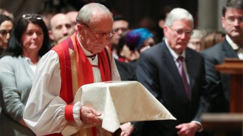 Reverend Gene Robinson carries the ashes of Matthew Shepard, whose 1998 kidnap and murder cast widespread attention on hate crimes against gay people