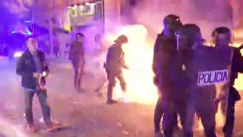A petrol bomb is thrown at police