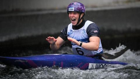 Kimberley Woods celebrates winning gold in her kayak