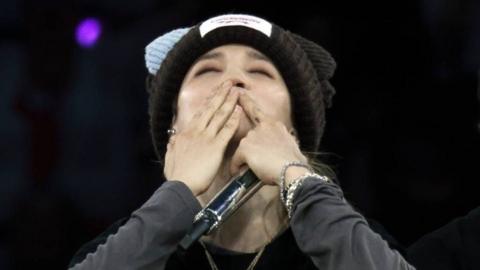 Jimin of BTS blows a kiss to fans during the band's show at Tottenham Hotspur Stadium