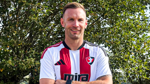 Andreas Weimann poses for a photo in the Cheltenham Town kit