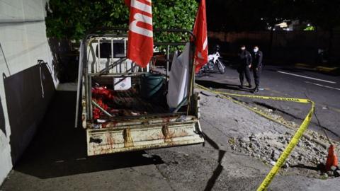 Police guard a truck that carried supporters of the political party Farabundo Marti Front (FMLN)