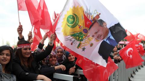 Supporters of President Recep Tayyip Erdogan cheer during his speech at the Presidential Palace in Ankara, on 17 April.