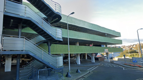 The exterior of the Tenby car park, with three storeys visible, and the entrance road 
