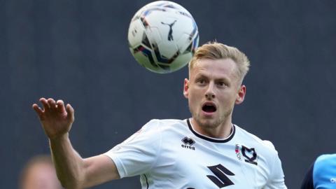 Harry Darling heads the ball