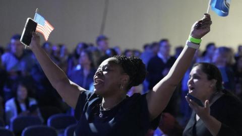 A woman celebrates, as Democrat Abigail Spanberger is projected to win